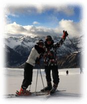 A young couple skiing in Turin with nice view of the Alps