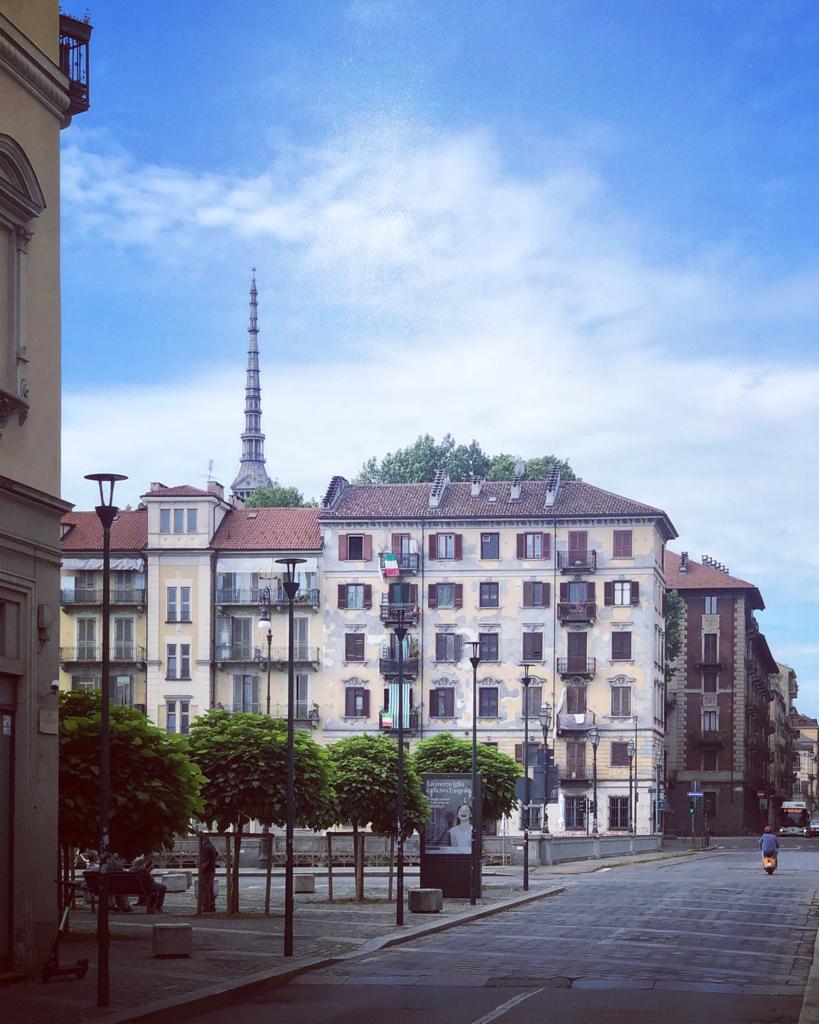 Picture of a neighborhood of Turin by day from which you can see the Mole Antonelliana