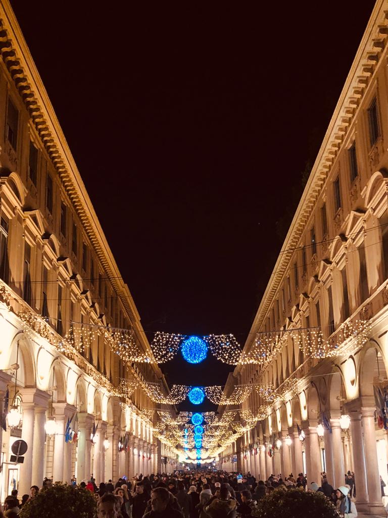 Picture of the Turin's main street Via Roma by night, crowded with people