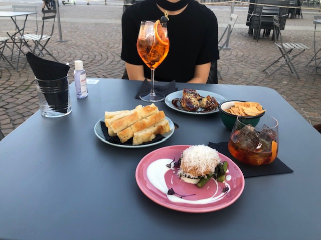 An assortment of Italian aperitivo food including focaccia, fried egg and olives at a bar in Turin, Italy