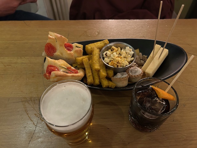 An assortment of Italian aperitivo food mainly pizza and fried polenta at a cafe/restaraunt in Turin, Italy